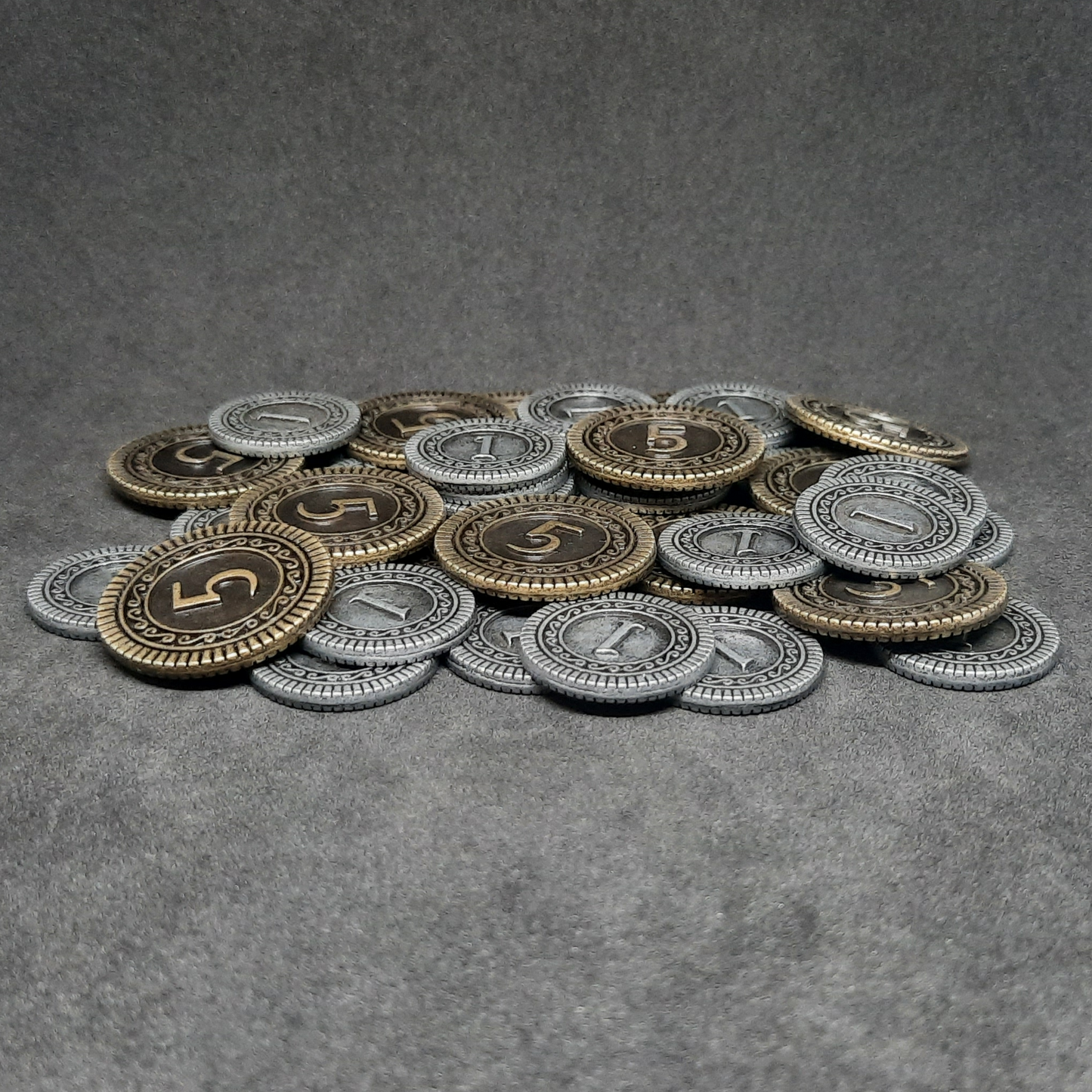 Set of silver and gold metal coins of value 1 and 5 for board games