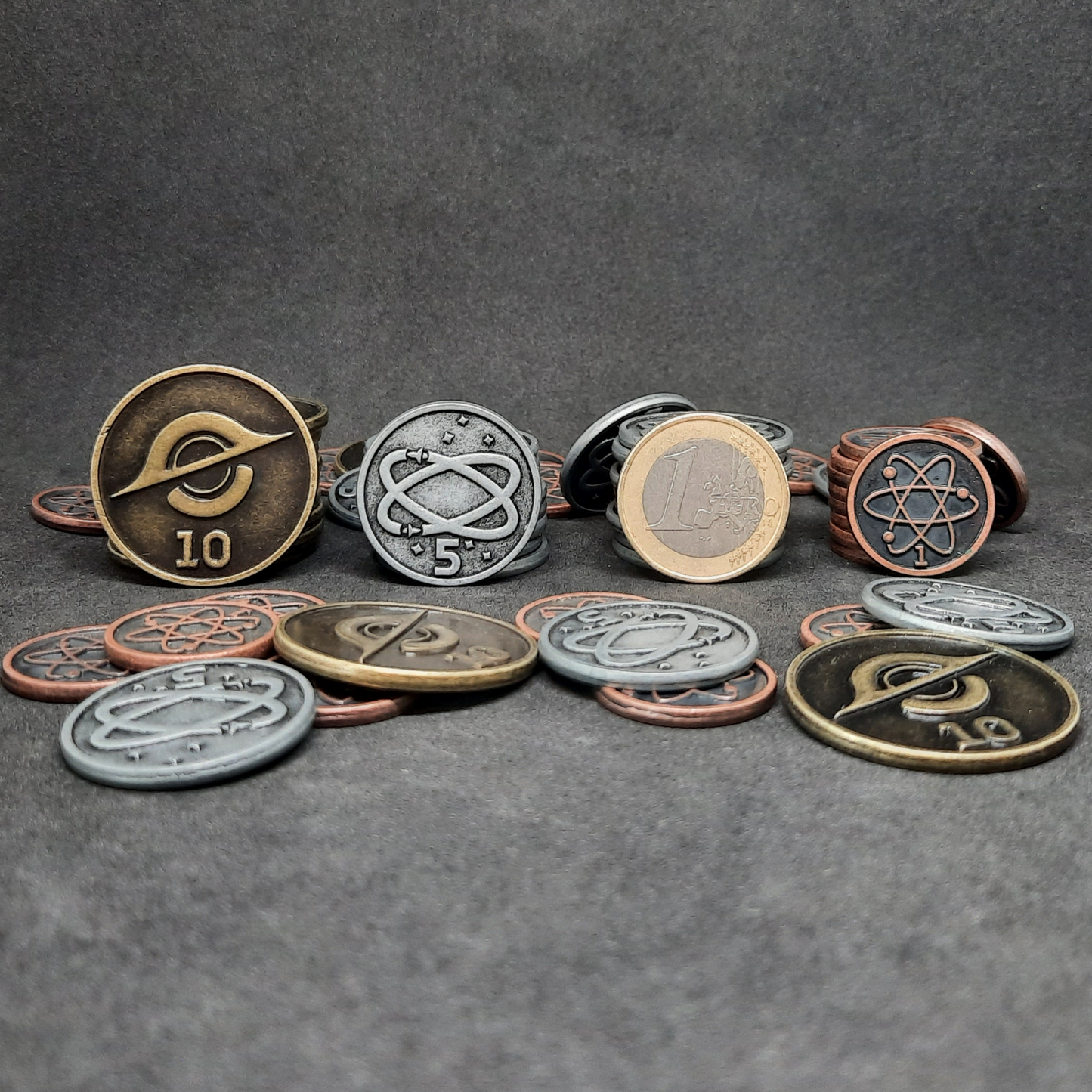 Set of bronze, silver and gold spatial metal coins of value 1, 5 and 10 for board games