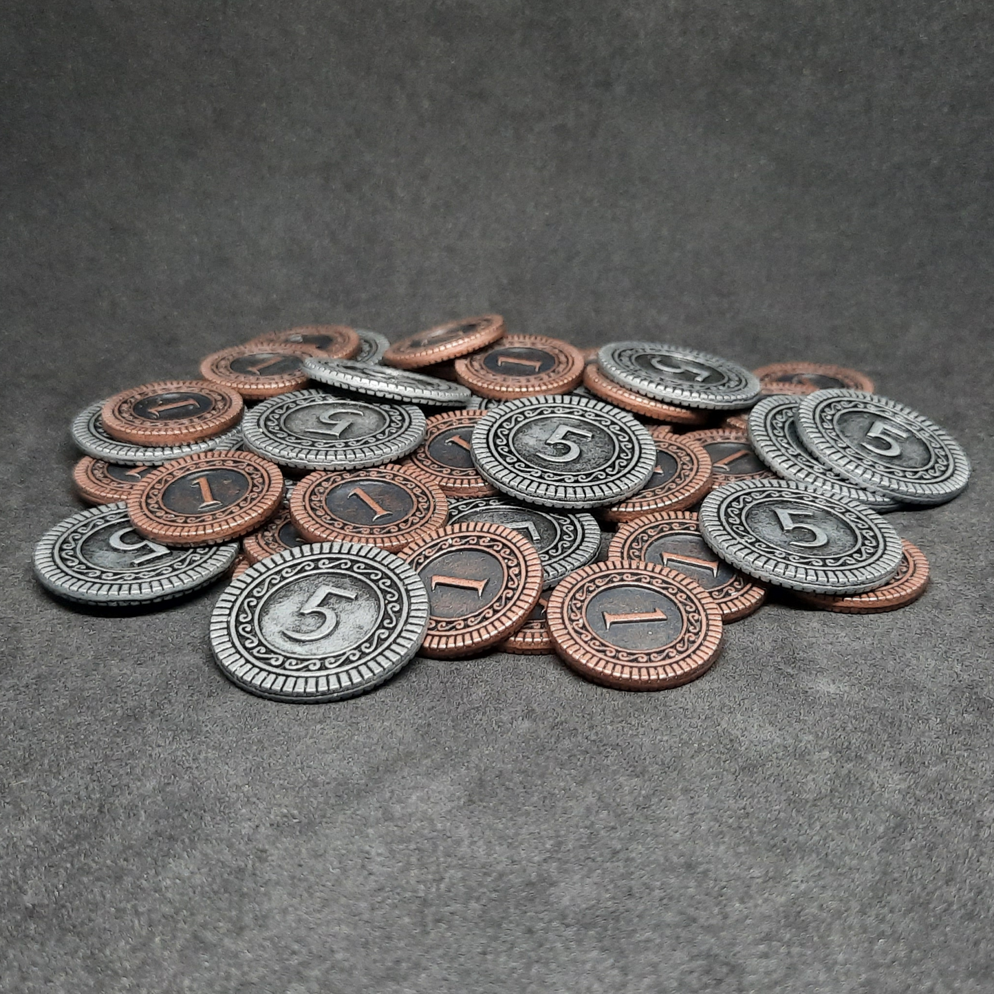 Set of bronze and silver metal coins of value 1 and 5 for board games