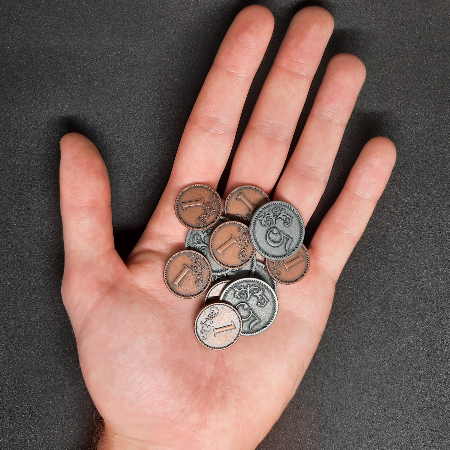 Set of bronze and silver metal coins of value 1 and 5 for board games