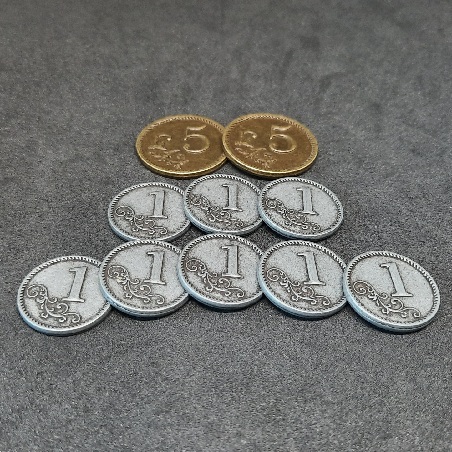 Set of silver and gold metal coins of value 1 and 5 for board games