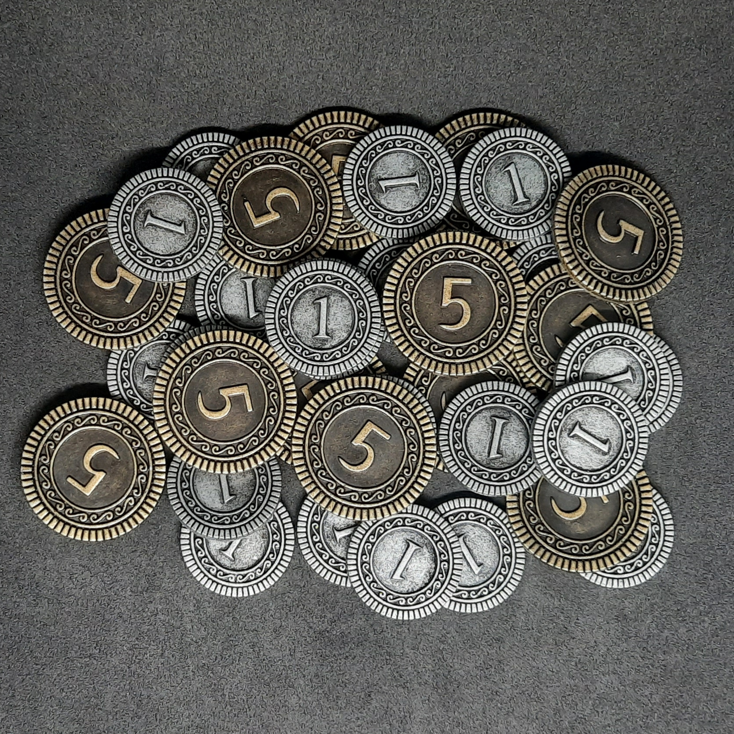 Set of silver and gold metal coins of value 1 and 5 for board games