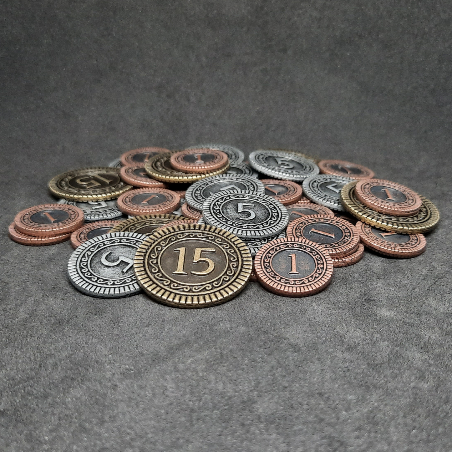 Set of bronze, silver and gold metal coins of value 1, 5 and 15 for board games