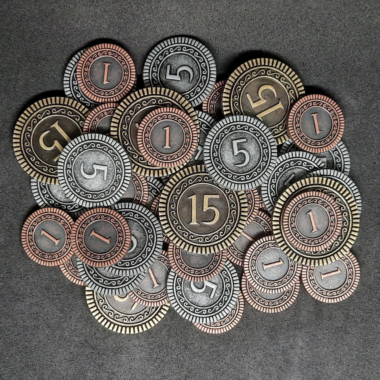 Set of bronze, silver and gold metal coins of value 1, 5 and 15 for board games