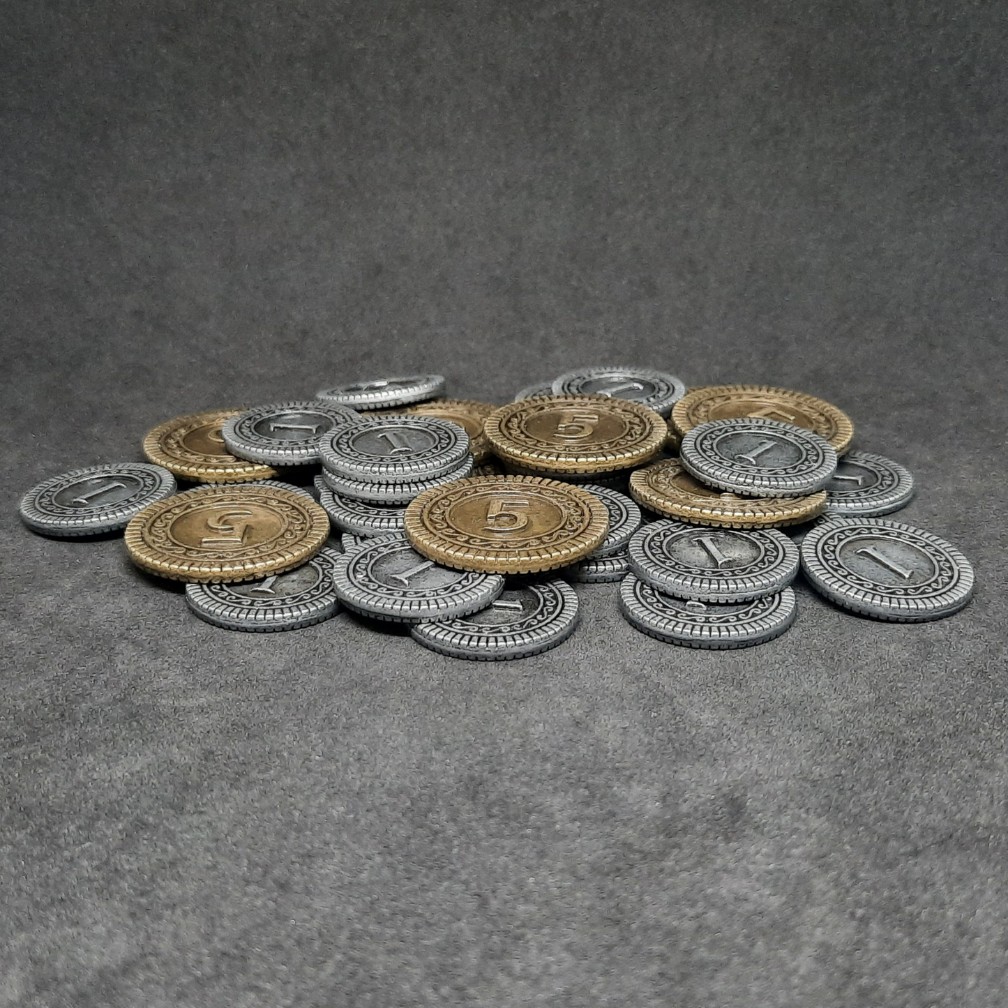 Set of silver and gold metal coins of value 1 and 5 for board games