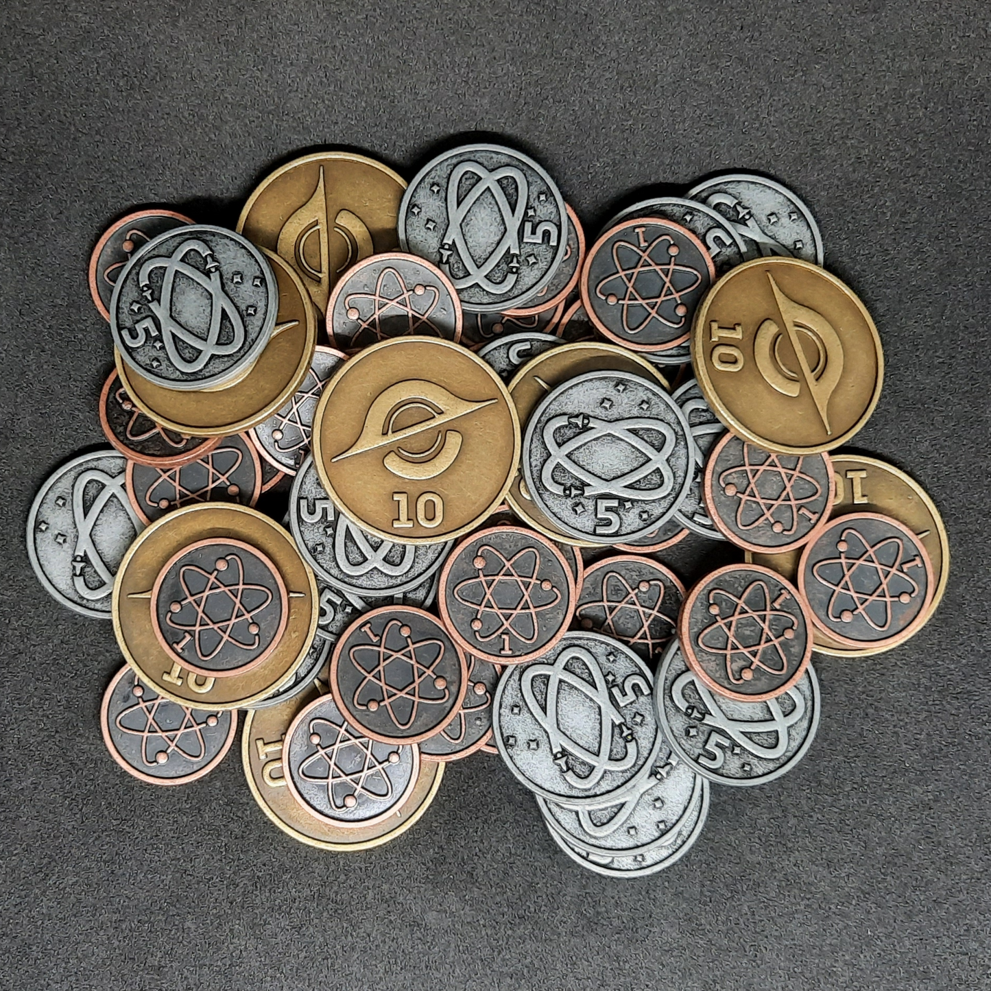 Set of bronze, silver and gold spatial metal coins of value 1, 5 and 10 for board games