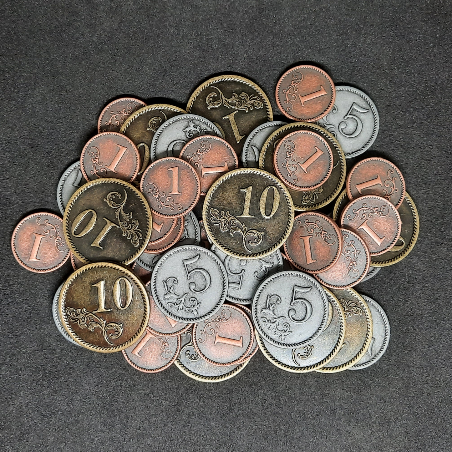 Set of bronze, silver and gold metal coins of value 1, 5 and 10 for board games