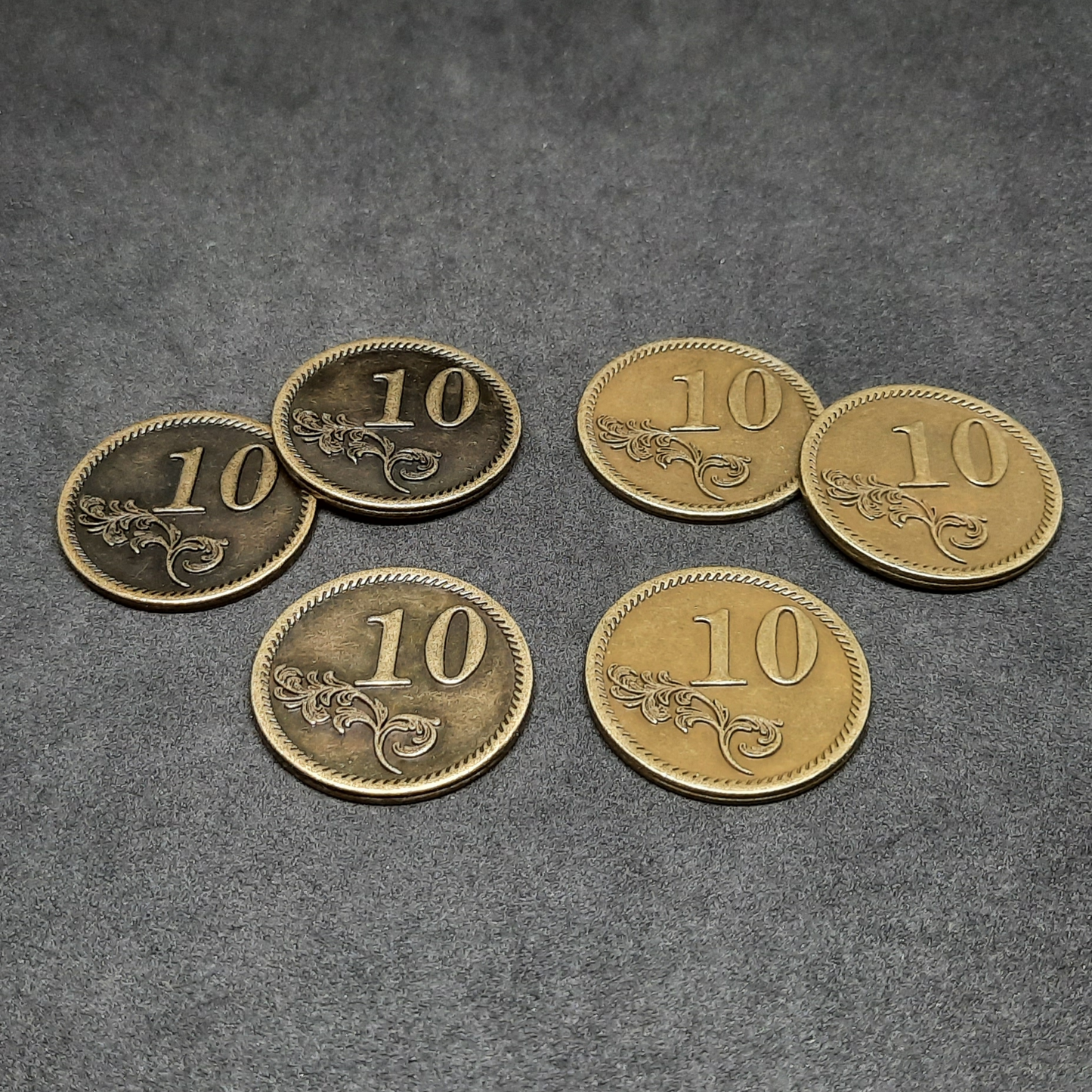 Set of bronze, silver and gold metal coins of value 1, 5 and 10 for board games