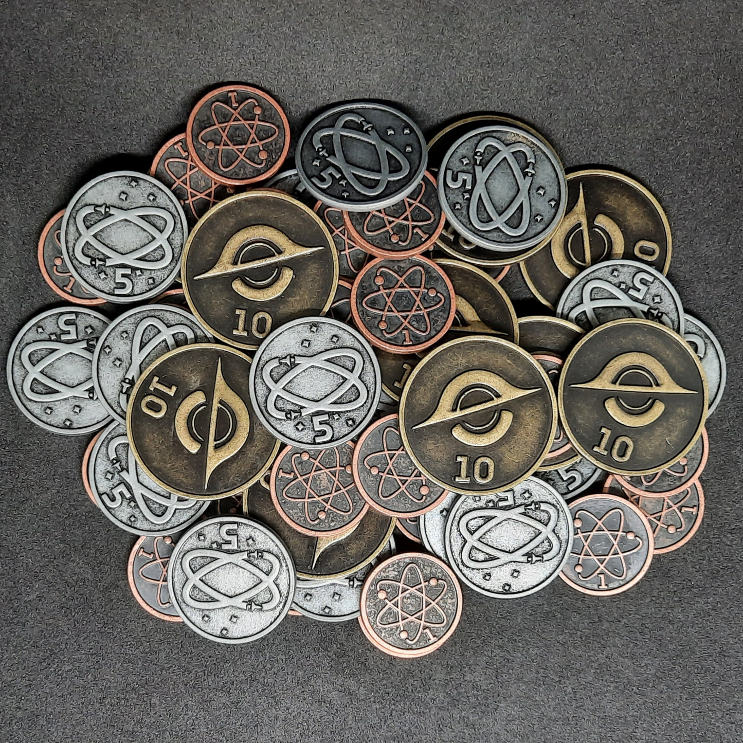 Set of bronze, silver and gold spatial metal coins of value 1, 5 and 10 for board games