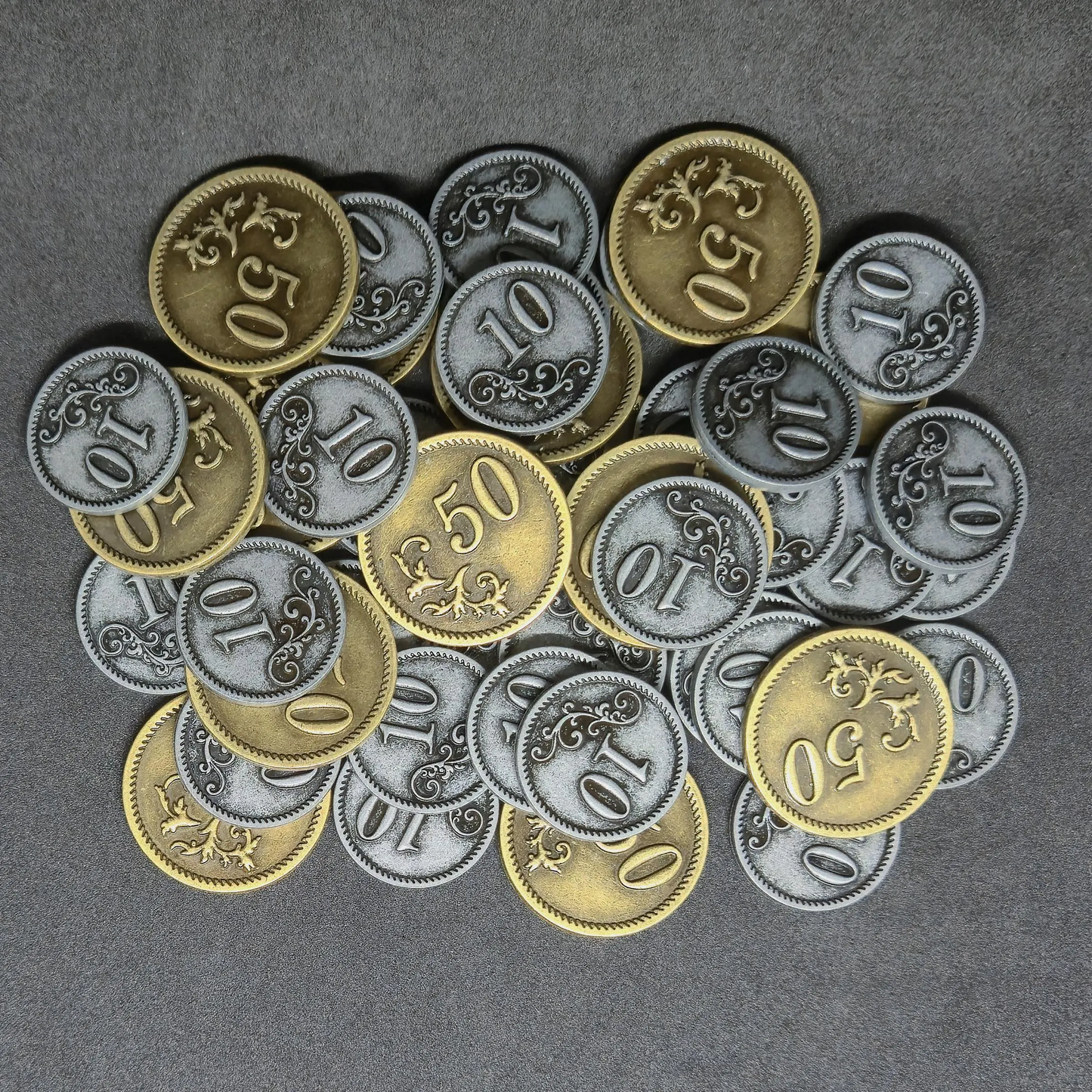 Set of silver and gold metal coins of value 10 and 50 for board games