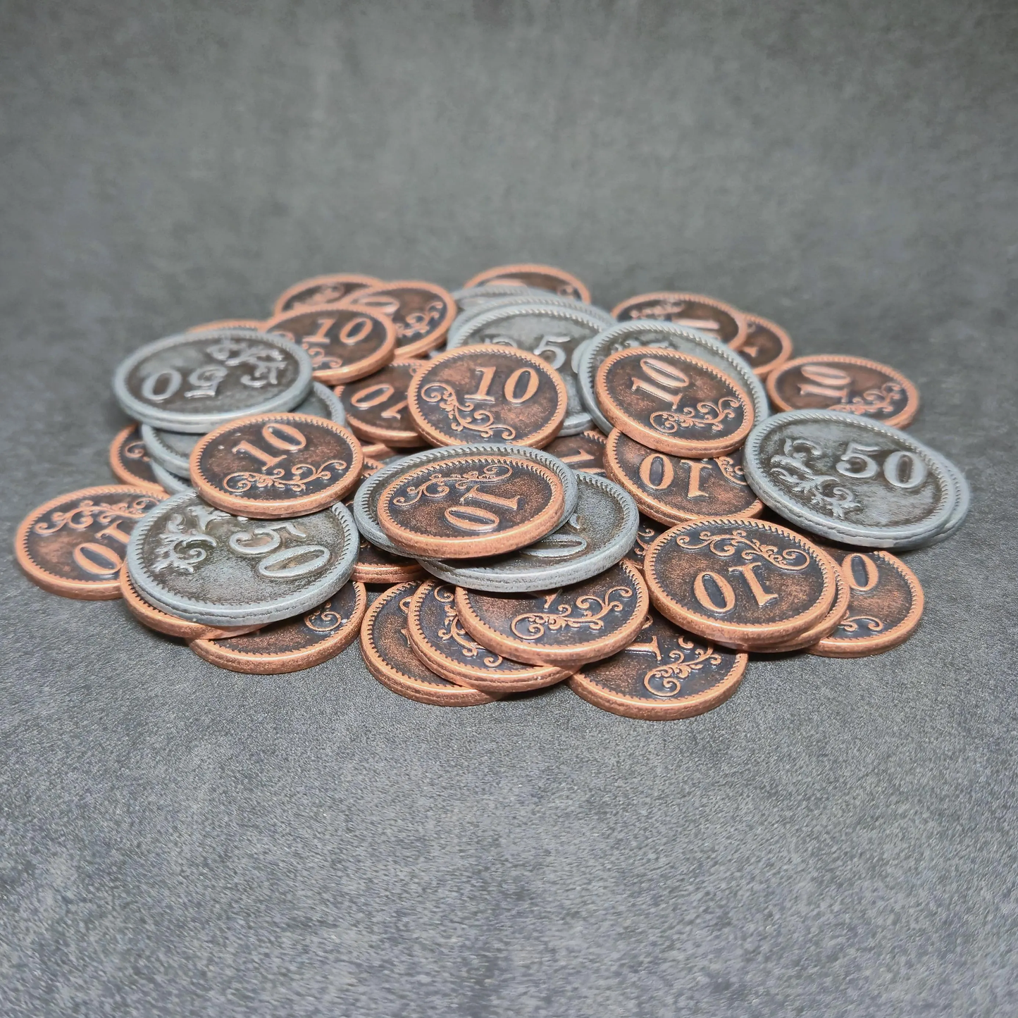 Set of bronze and silver metal coins of value 10 and 50 for board games