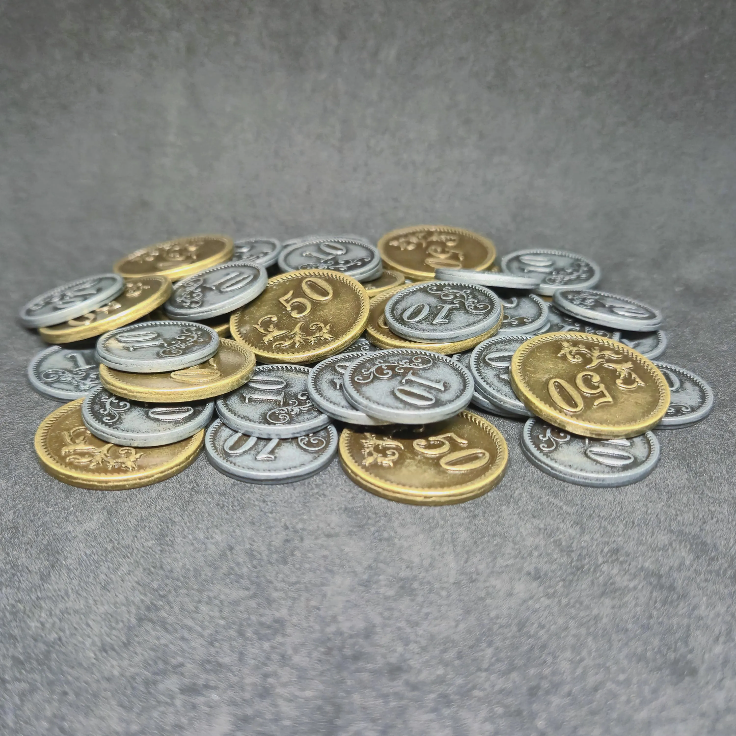 Set of silver and gold metal coins of value 10 and 50 for board games