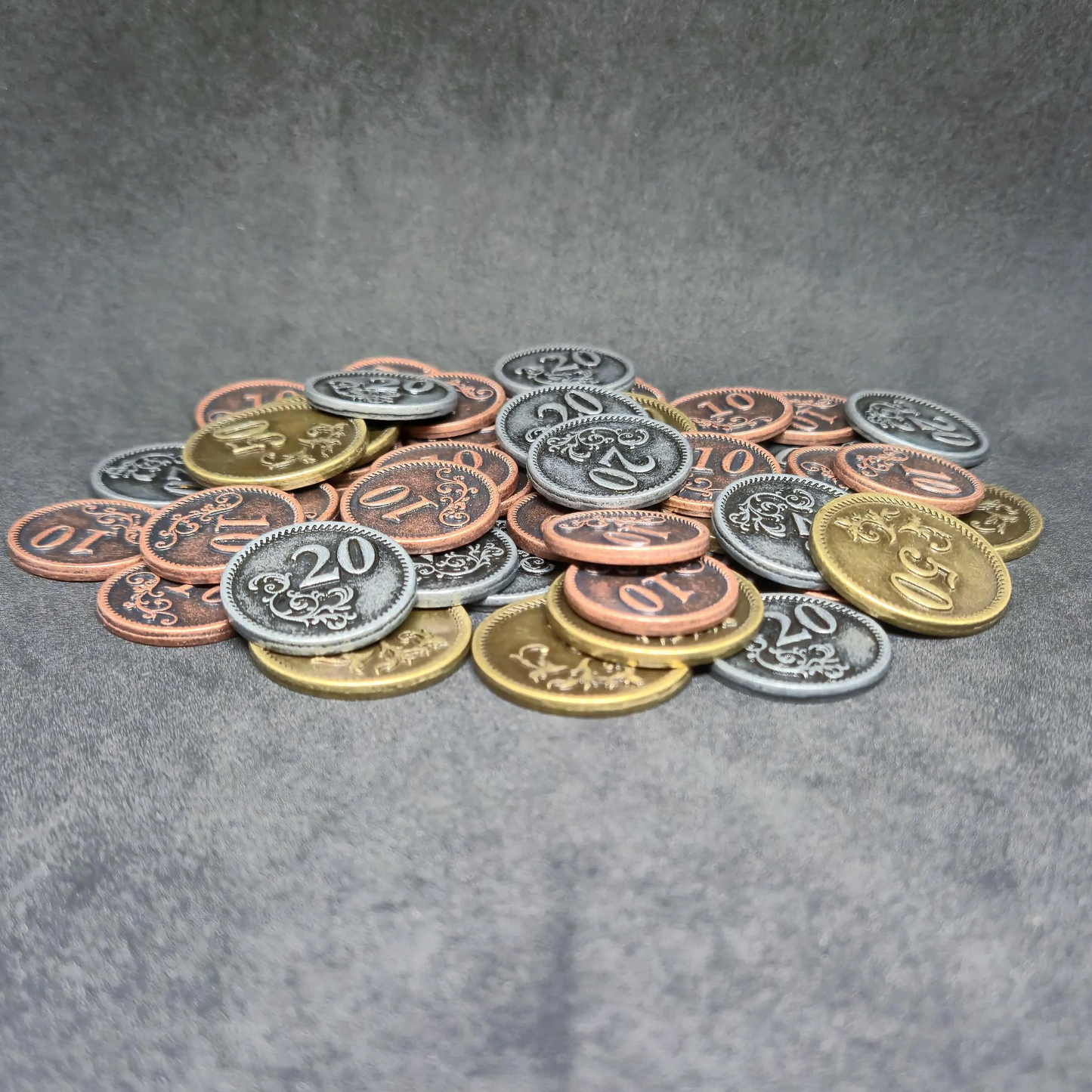 Set of bronze, silver and gold metal coins of value 10, 20, and 50 for board games