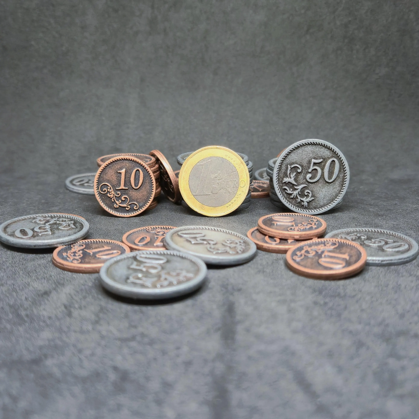 Set of bronze and silver metal coins of value 10 and 50 for board games