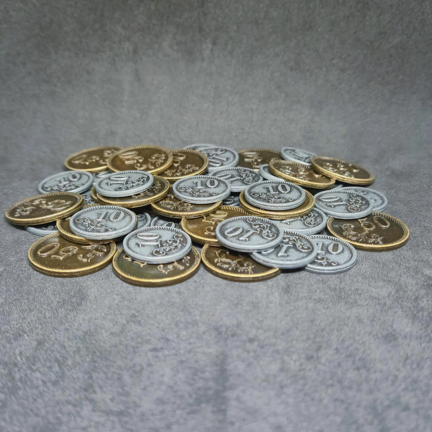 Set of silver and gold metal coins of value 10 and 50 for board games