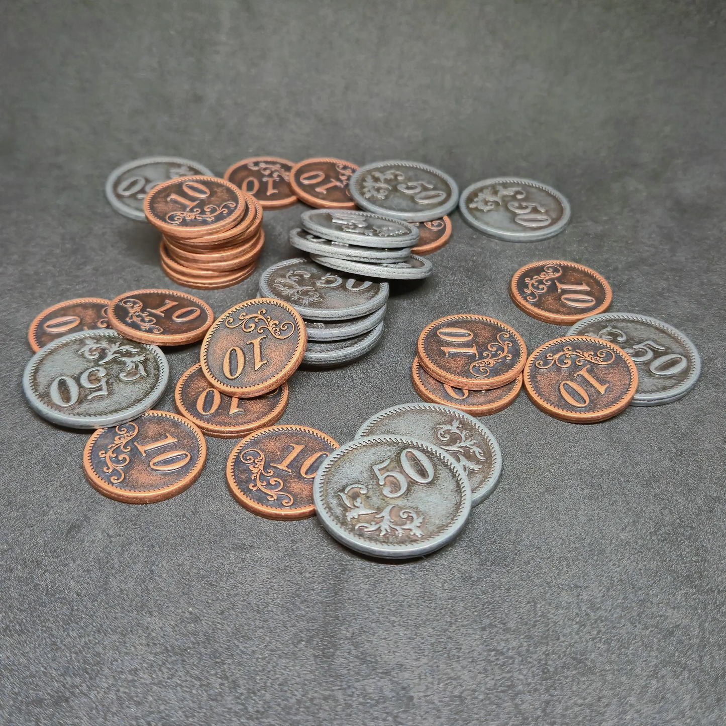 Set of bronze and silver metal coins of value 10 and 50 for board games