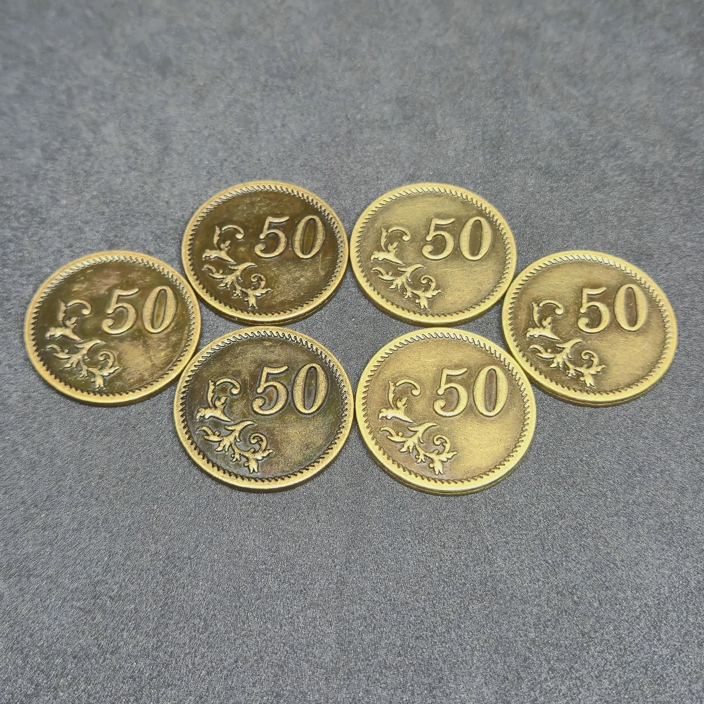 Set of silver and gold metal coins of value 10 and 50 for board games