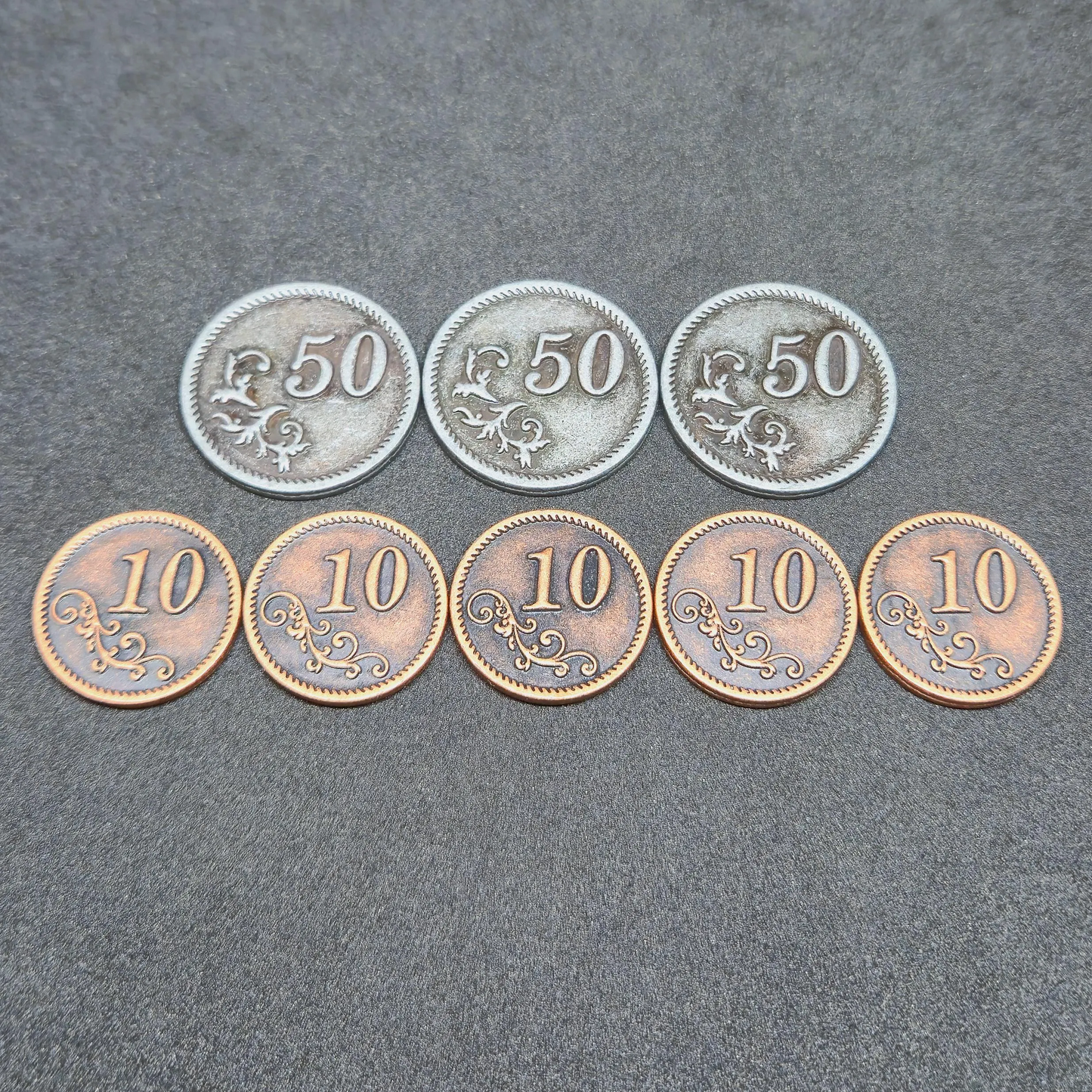 Set of bronze and silver metal coins of value 10 and 50 for board games