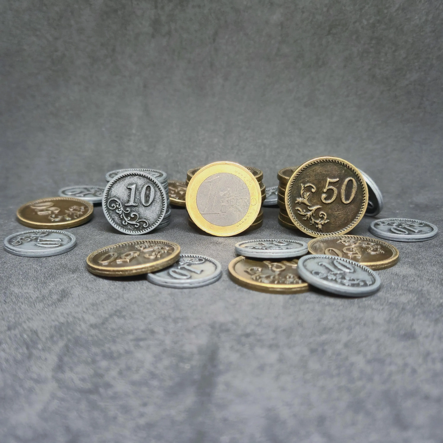 Set of silver and gold metal coins of value 10 and 50 for board games