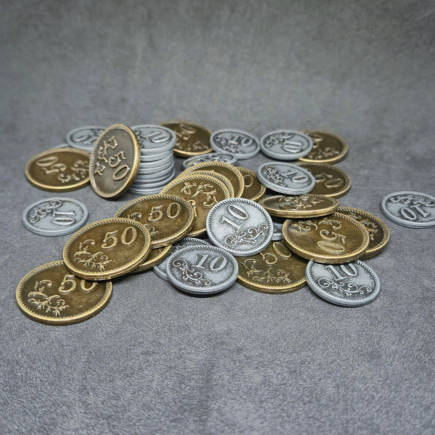 Set of silver and gold metal coins of value 10 and 50 for board games