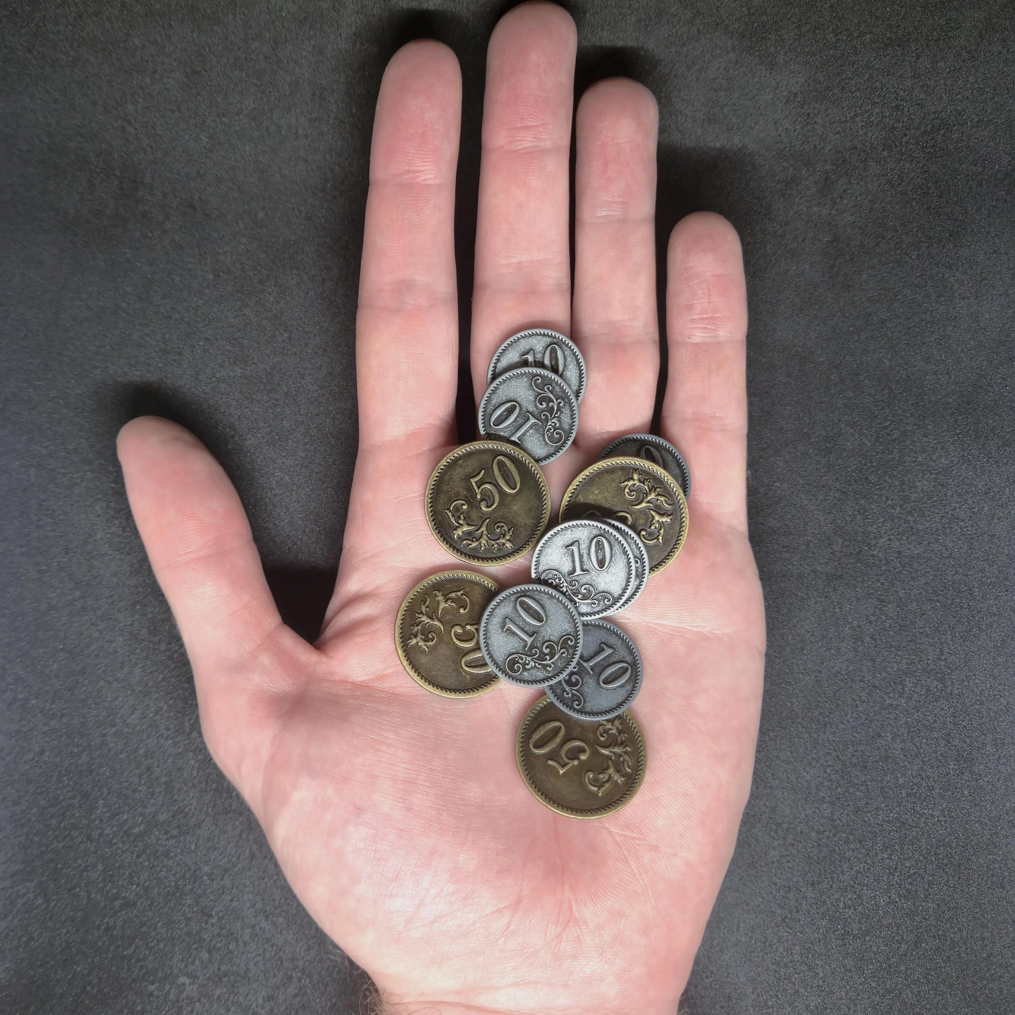 Set of silver and gold metal coins of value 10 and 50 for board games